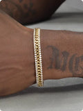 Gold titanium steel hip hop style tennis bracelet with artificial gemstone inlays for men and women.