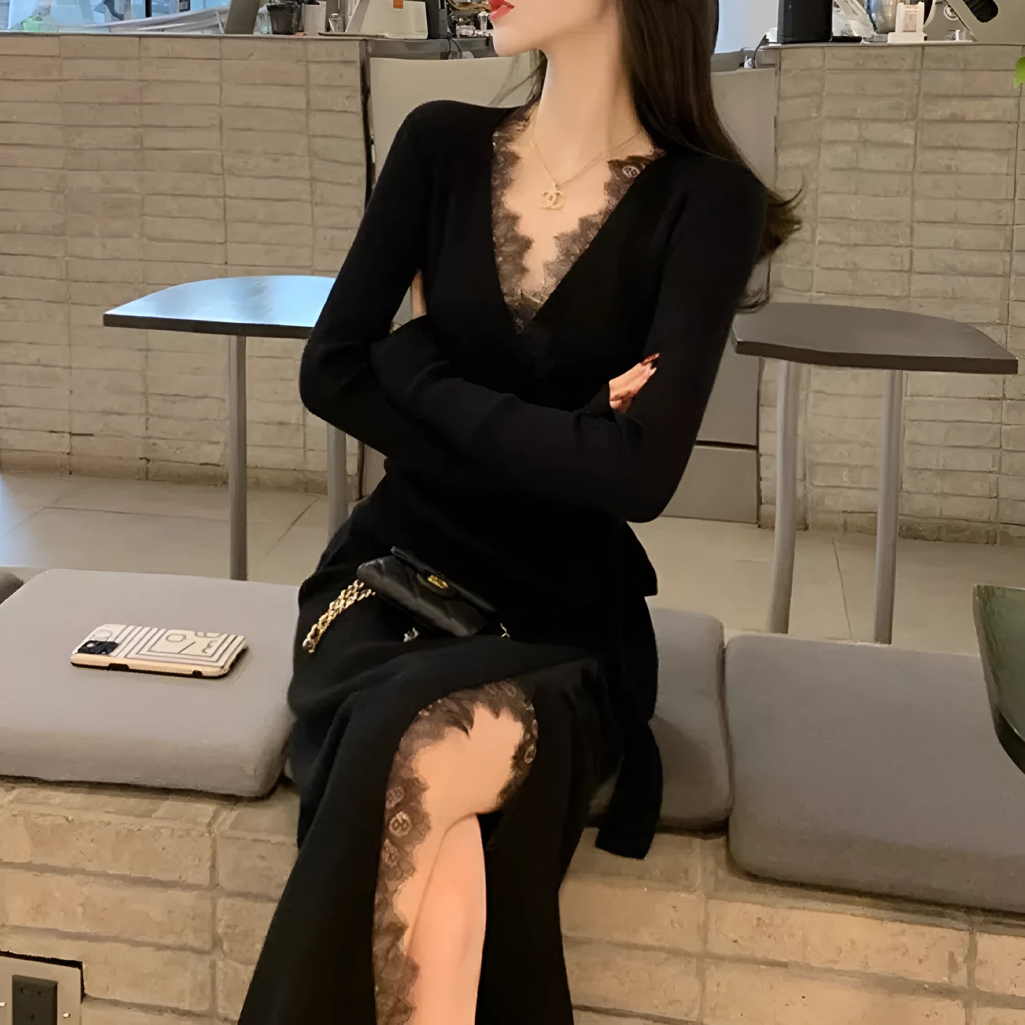 Black slim fit wool skirt dress with a princess A-line silhouette on a hanger.