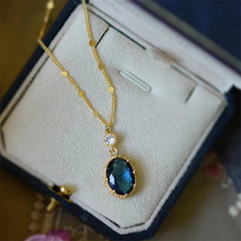 Gold-coloured geometric pendant necklace with a French retro design on a chain.