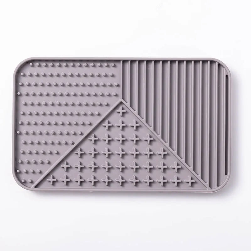 Silicone pet licking mat with textured surface and suction cup base in pink colour