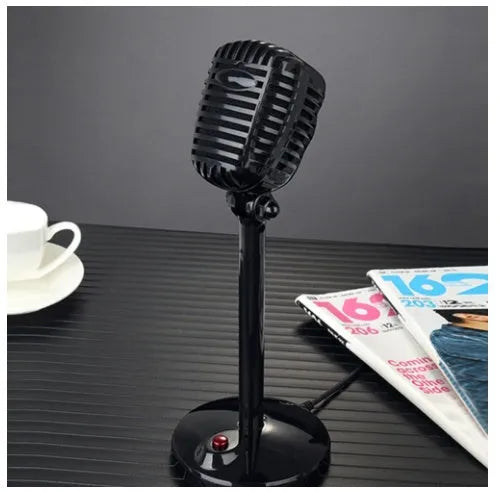 Black USB condenser microphone with stand, adjustable neck, and foam windscreen, placed on a desk