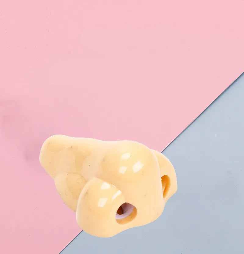 Flesh coloured plastic manual pencil sharpener with geometry shape and large nostril opening