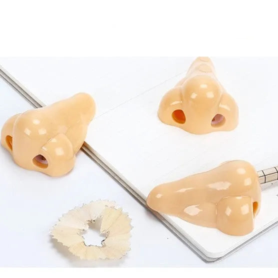 Flesh coloured plastic manual pencil sharpener with geometry shape and large nostril opening