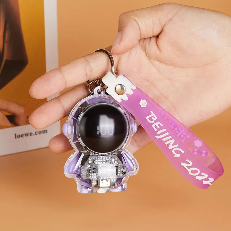 Small keychain emergency power bank in orange plastic shell with cartoon-style design and keyring attachment