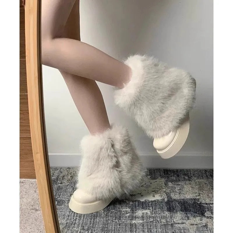 Women's black fleece-lined low-top snow boots with a waterproof rubber platform sole on a white background.
