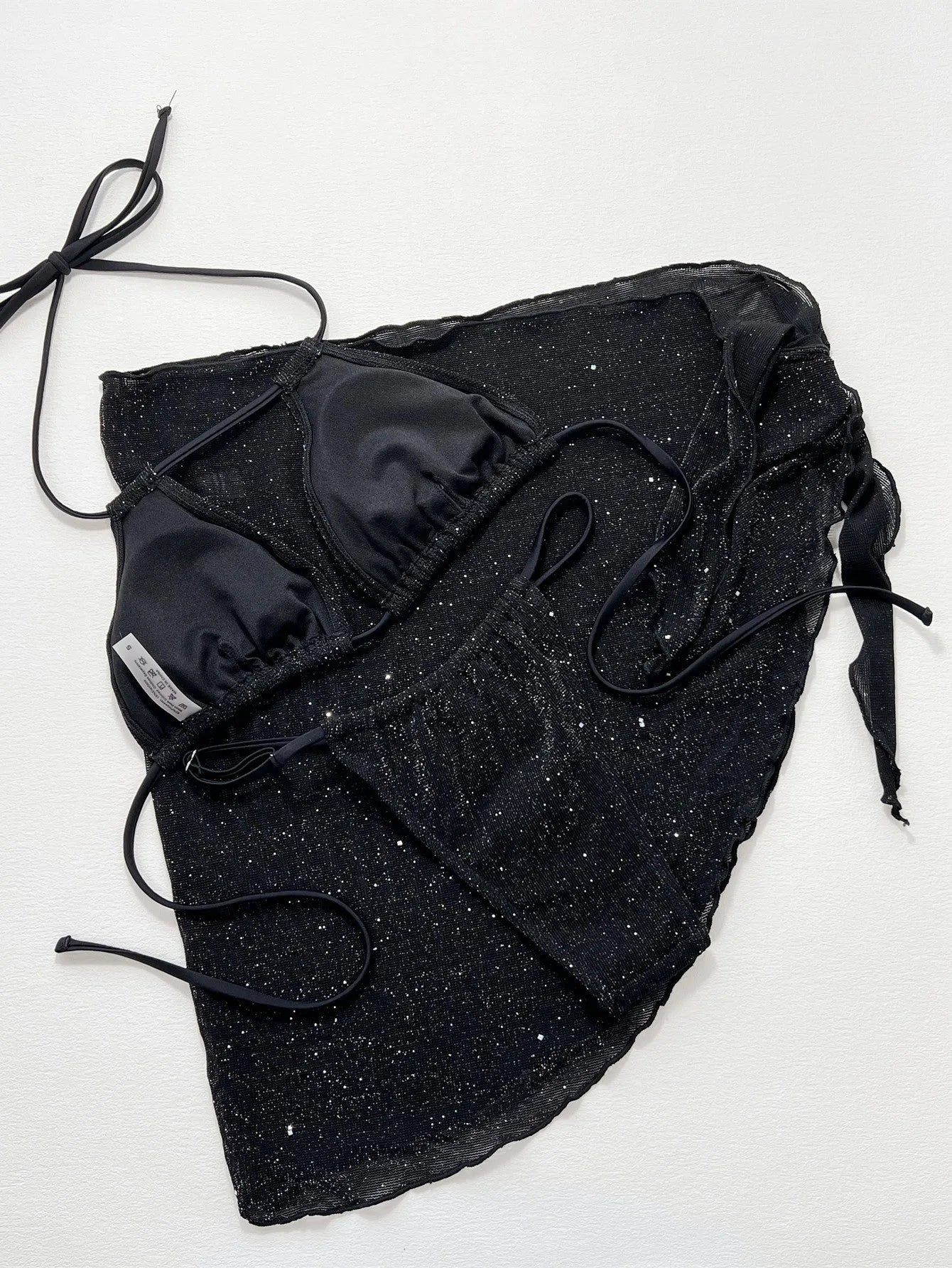 Black three-piece swimsuit bikini set with high-waisted shorts on mannequin