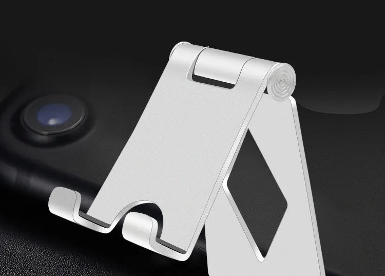 Aluminium alloy folding mobile phone desktop stand in black colour on a desk surface