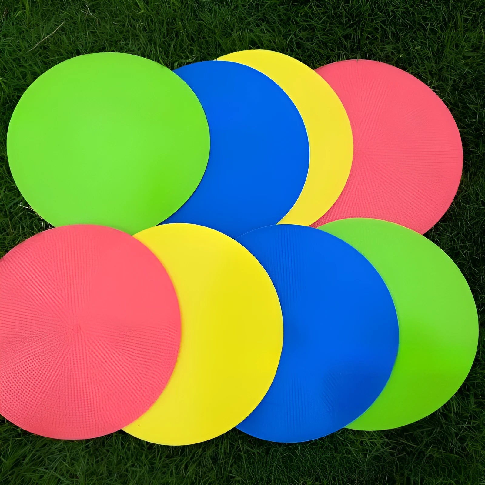 23cm diameter football training landmark pad in bright colours on grass field