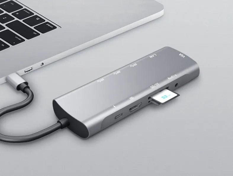 Grey aluminium USB C docking station with HDMI, VGA, and USB ports.