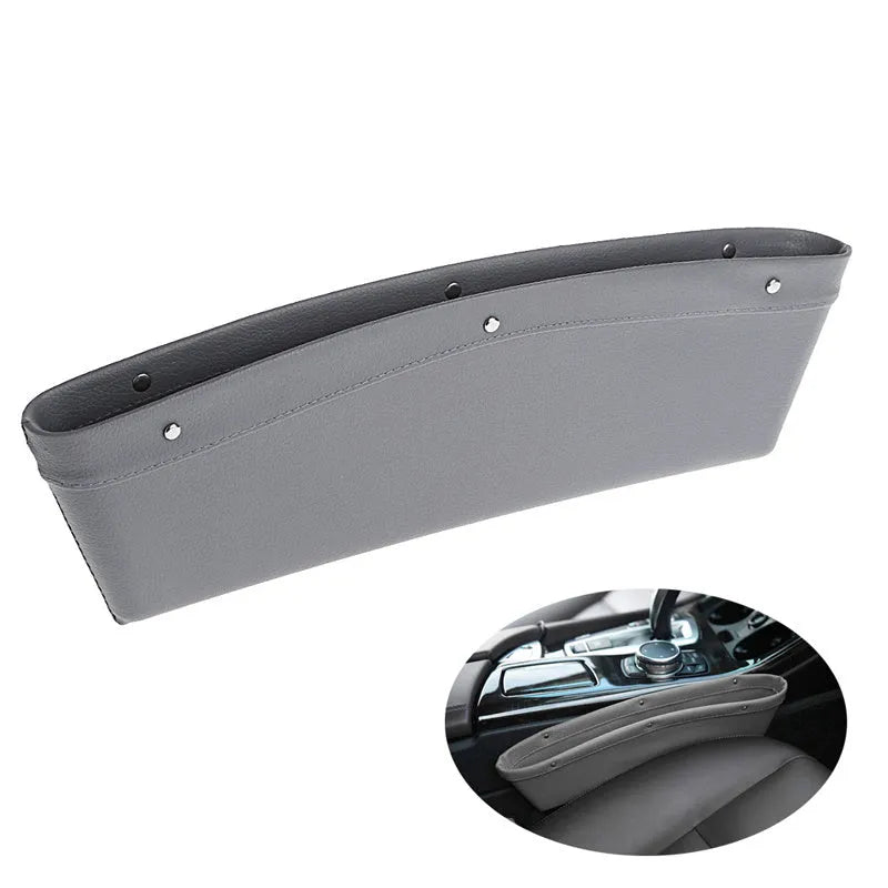 Faux leather car seat gap organiser in black holding phone, keys, and bills, fitted between car seat and centre console.