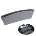 Faux leather car seat gap organiser in black holding phone, keys, and bills, fitted between car seat and centre console.
