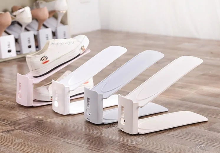Double-layer adjustable shoe storage rack in white, holding two pairs of shoes