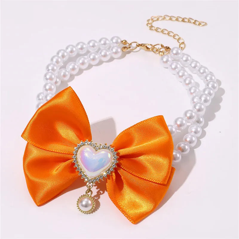 Cute heart shape princess style pet necklace with pearl beads on pink background