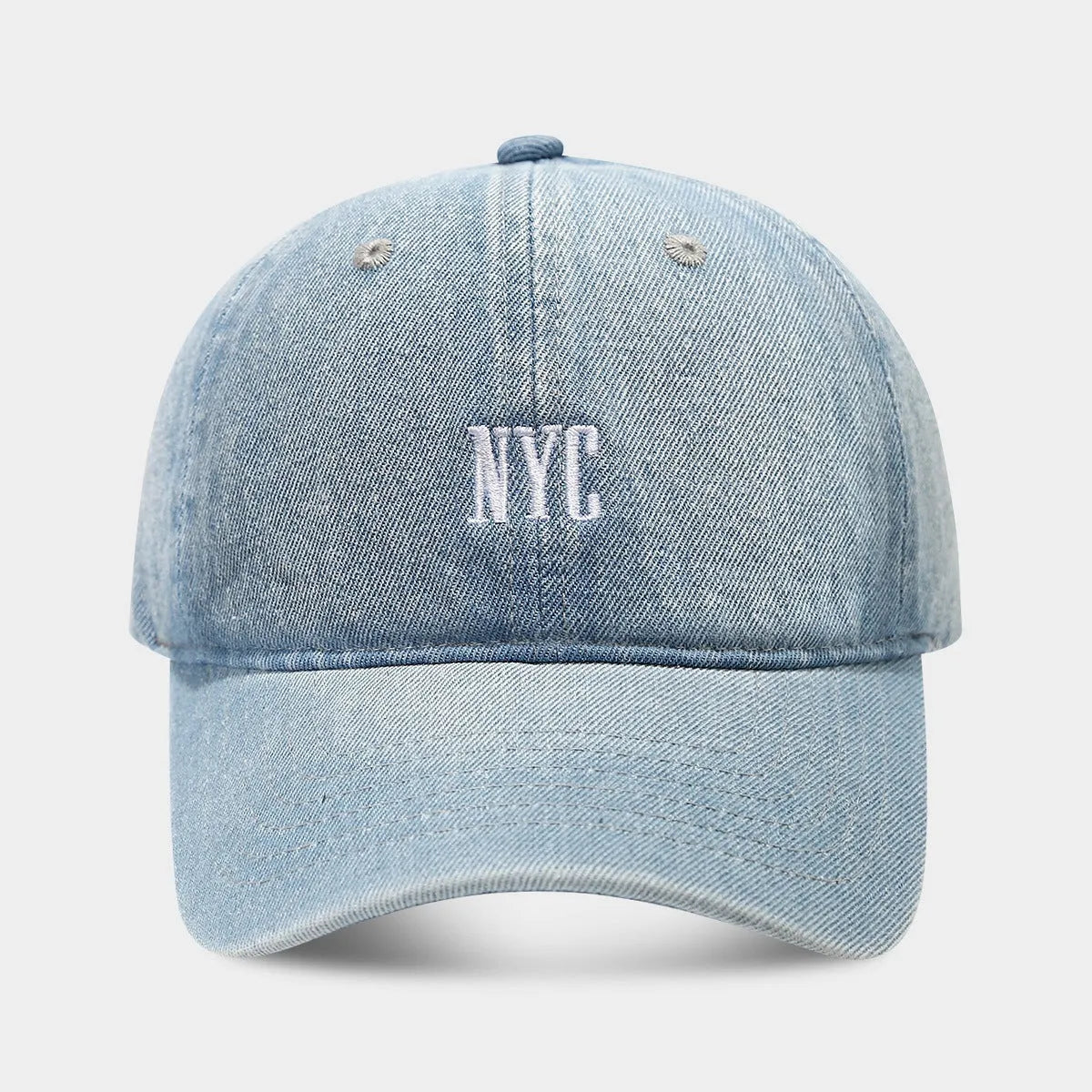 Retro denim peaked cap with embroidered letters on the front, shown in an adjustable size.