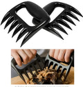 Black bear claw meat shredder utensil for pulling pork and chicken on a kitchen surface.