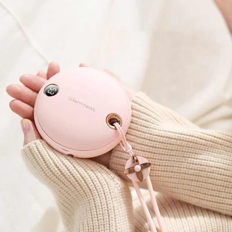 Green, pink or white 5000mAh power bank with digital display and integrated hand warmer function.