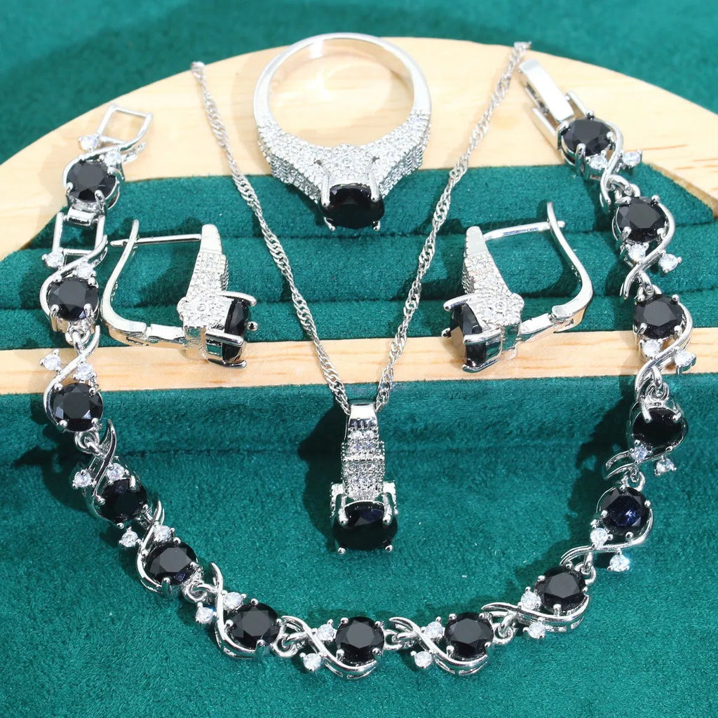 Bridal zircon alloy jewellery four-piece set showing necklace, earrings, ring and bracelet on water wave chain