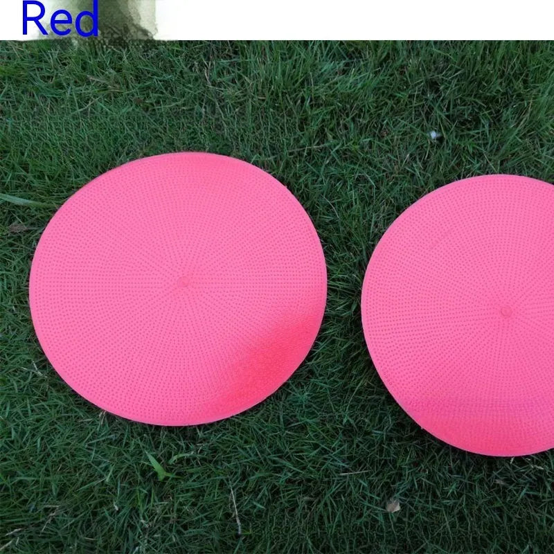 23cm diameter football training landmark pad in bright colours on grass field