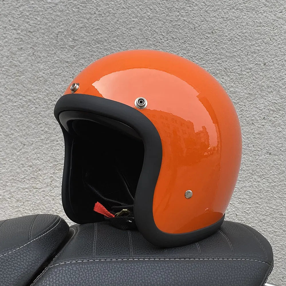 A retro-style grey half helmet for motorcycle riding, shown on a stand.