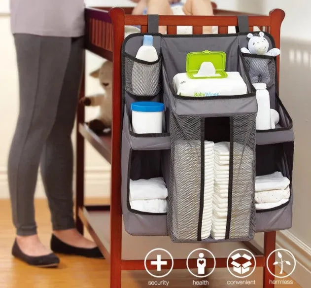 Gray baby diaper organizer hanging on crib with adjustable Velcro straps, TC Oxford cloth construction