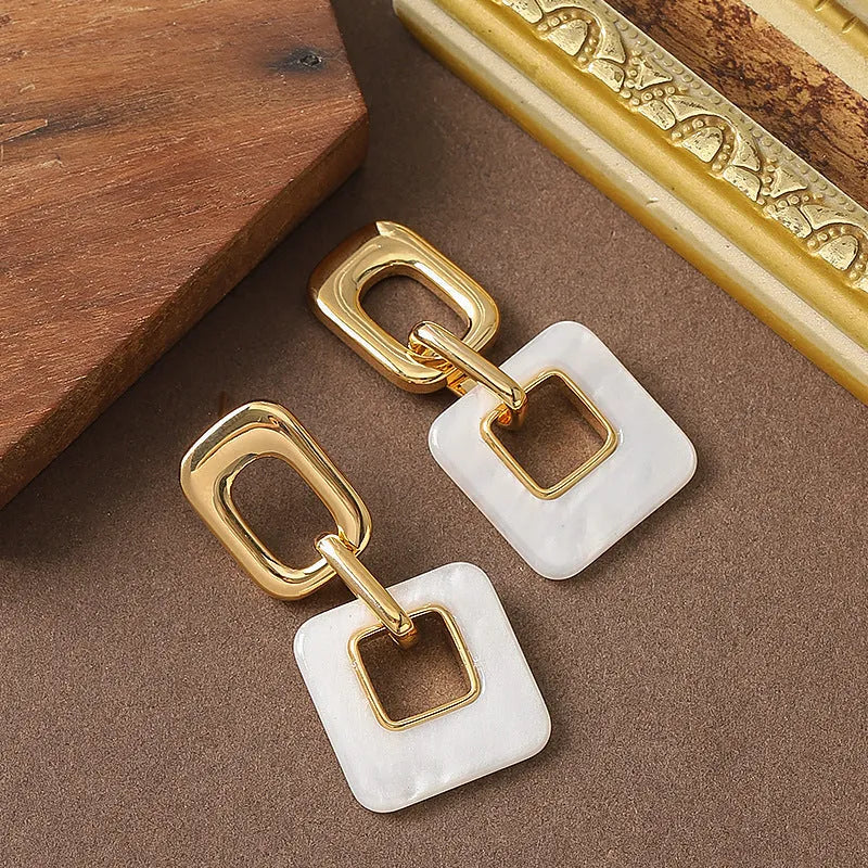 Hollow geometric square earrings with chamfered pattern in electroplated copper