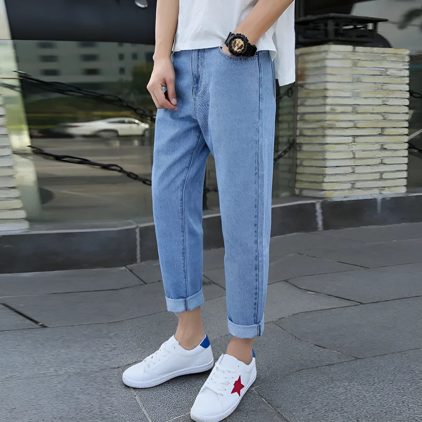 Men's black cotton straight-leg jeans with loose harem fit on adult male model
