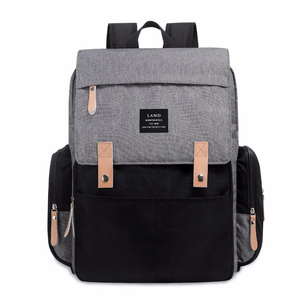 Land Mommy large oxford cloth diaper backpack in grey with a changing mat, shown open.