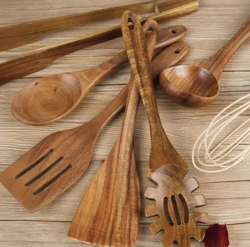 Wooden cooking utensil set with seven different kitchen tools including spoon and shovel