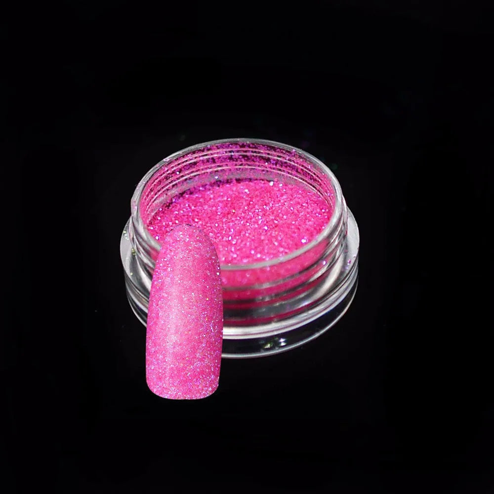 Six 1g pots of neon nail glitter powder in blue, green, orange, pink, purple, and yellow colours on a white background