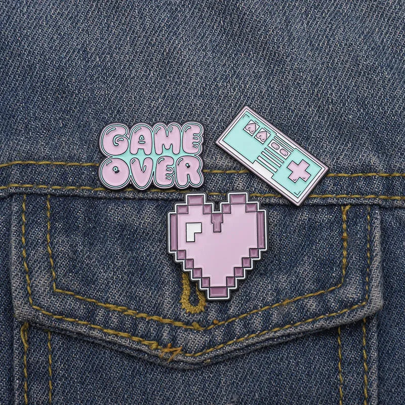 Stereo game console metal alloy badge with pin back, shown in available colours on a backpack strap
