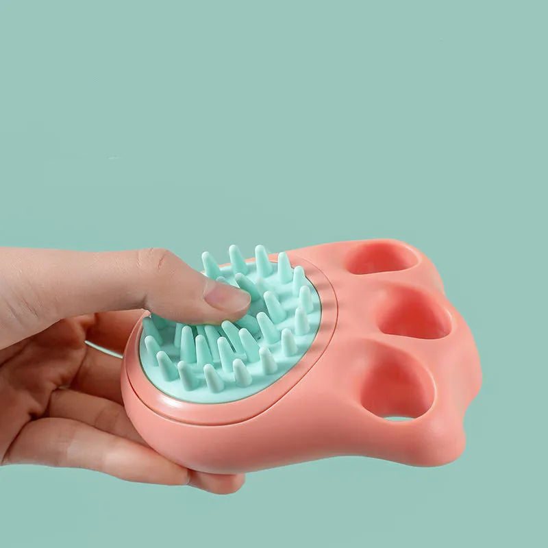 Blue pet bath and massage brush with silicone bristles and an ergonomic non-slip handle.