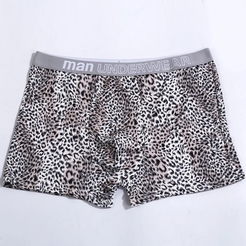 Men's loose fit leopard print underwear in grey and yellow, showing mid-waist design and soft fabric texture.