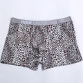 Men's loose fit leopard print underwear in grey and yellow, showing mid-waist design and soft fabric texture.
