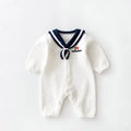 Navy cotton baby onesie with long sleeves and detachable hood on white background
