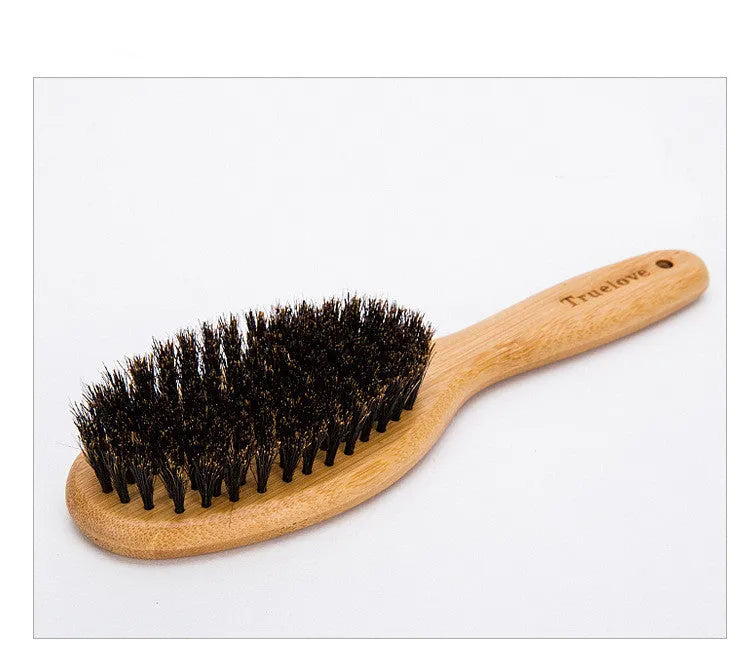 Medium pet deshedding comb with bamboo handle and stainless steel needles in original bamboo colour on a flat surface