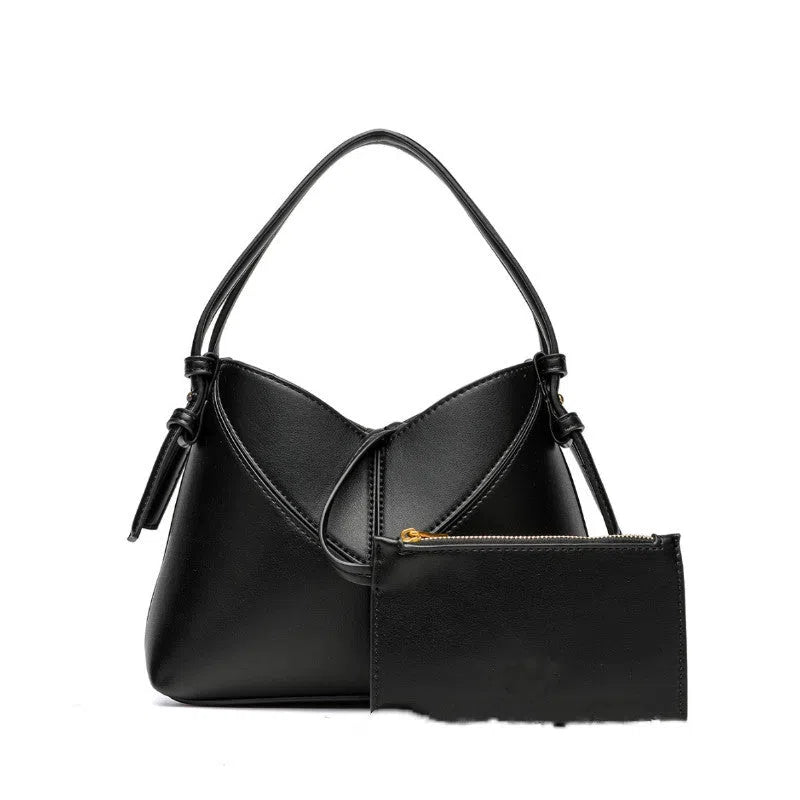 Women's oval PU handbag crossbody bag in black with stitched design and single shoulder strap
