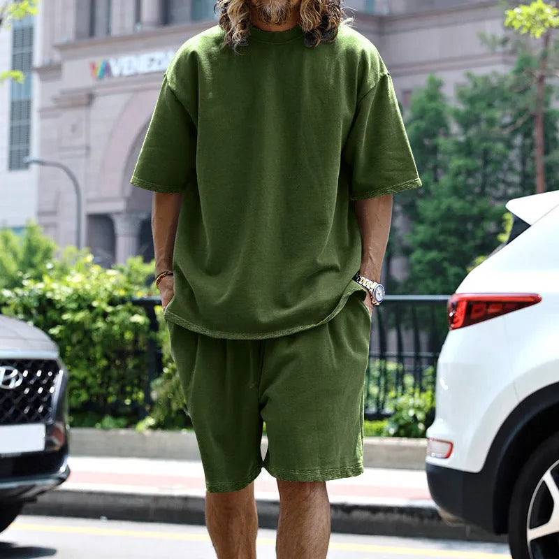 Men's casual sports suit set with grey round neck T-shirt and drawstring shorts on model