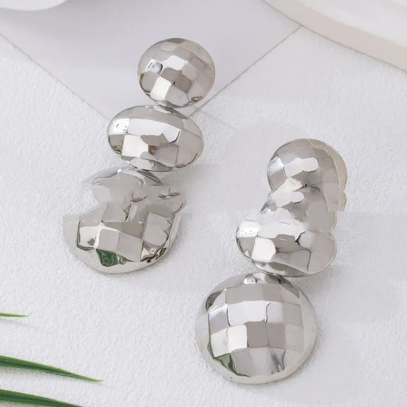Retro women's polka dot metal bead drop earrings in frosted gold finish on a neutral background