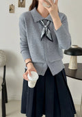 Milky white acrylic fibre cardigan sweater with a lapel scarf and long sleeves laid flat