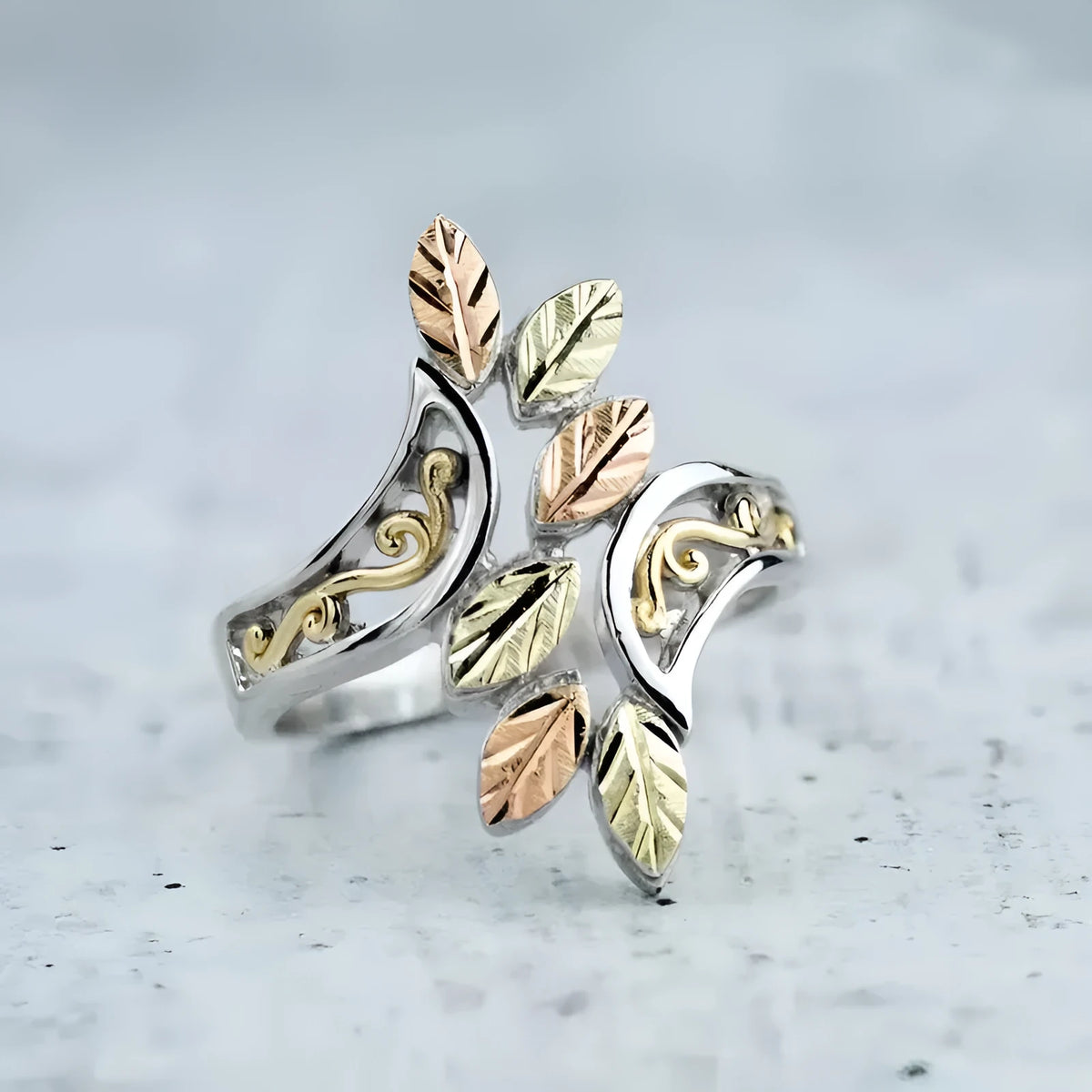 Hollow two-tone silver zinc alloy ring for women on flat surface, sizes 6 to 10 available