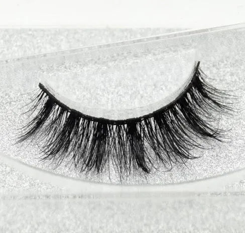 Pair of faux mink eyelashes with long tail and cotton stem against white background