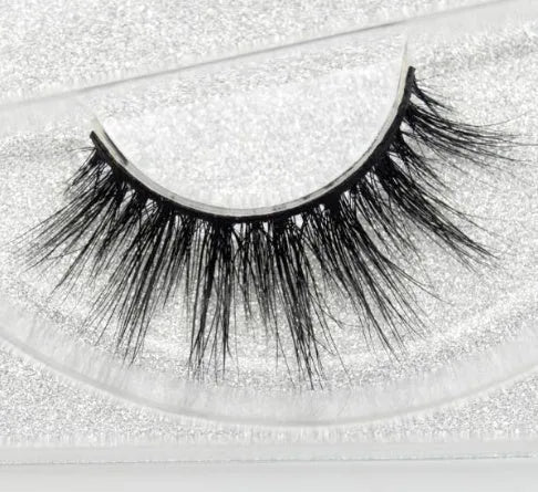 Pair of faux mink eyelashes with long tail and cotton stem against white background