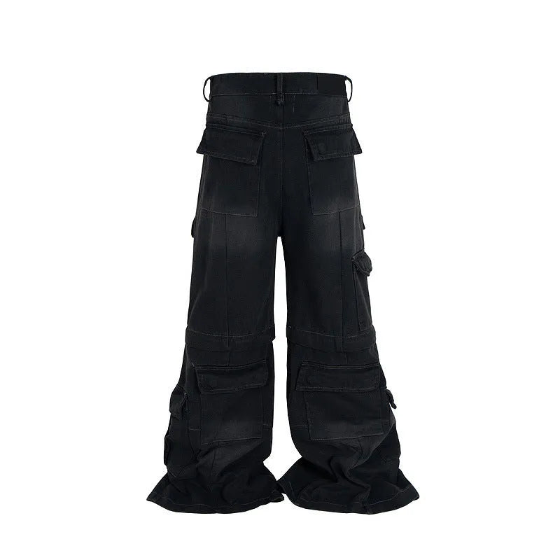 Black washed-out cotton overalls with detachable straps and multiple pockets on a hanger.