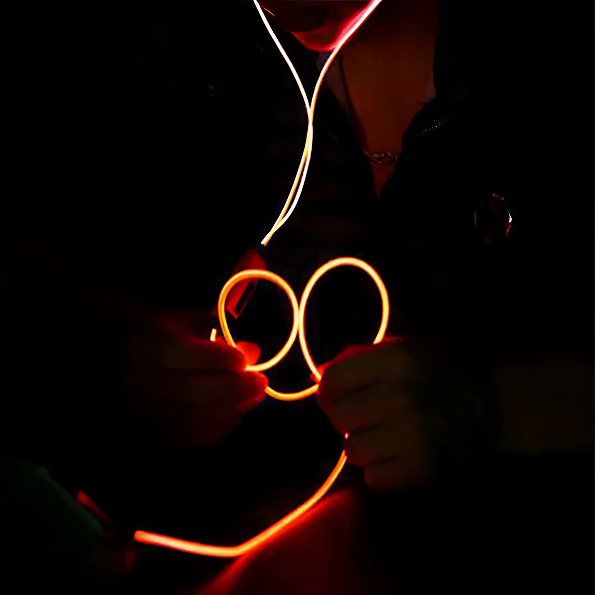 Blue Magic Light LED earphones with glowing EL light strips, showing 3.5mm plug and inline remote with microphone.
