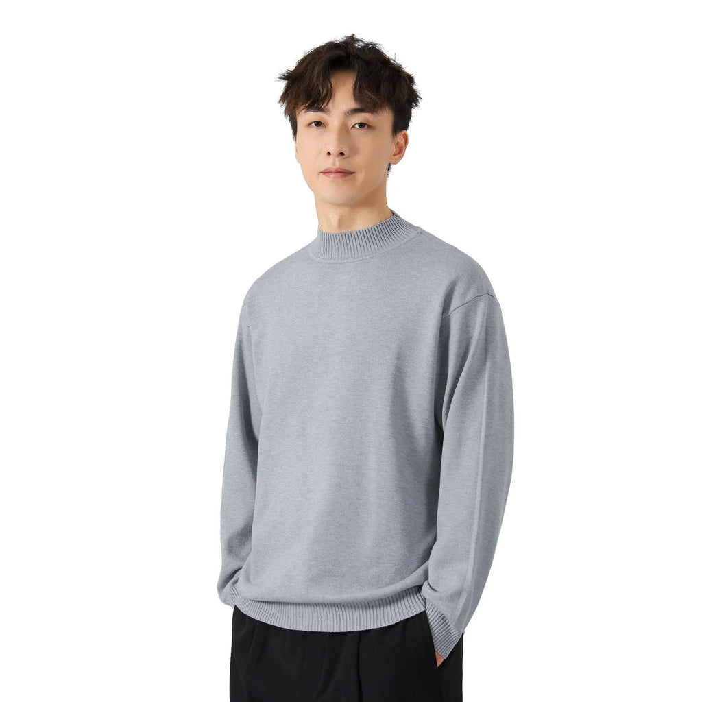 A man's loose-fitting, long-sleeve pullover sweater in a solid colour, showing a casual relaxed fit.
