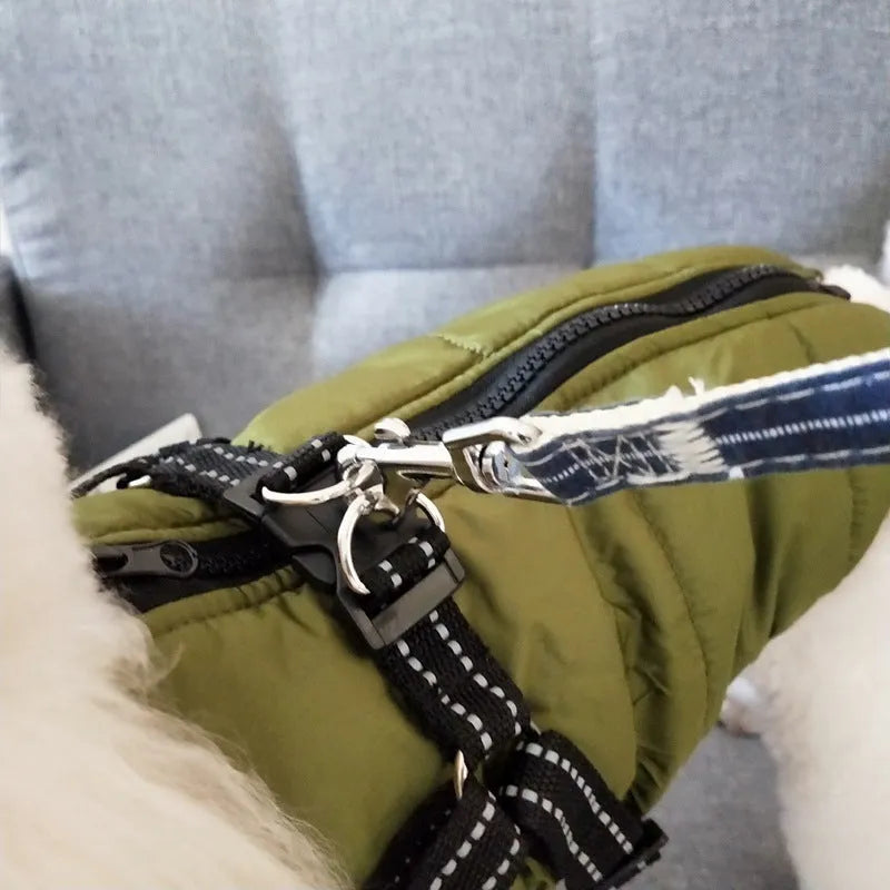Waterproof dog coat with harness in red, navy blue, and army green on a winter background