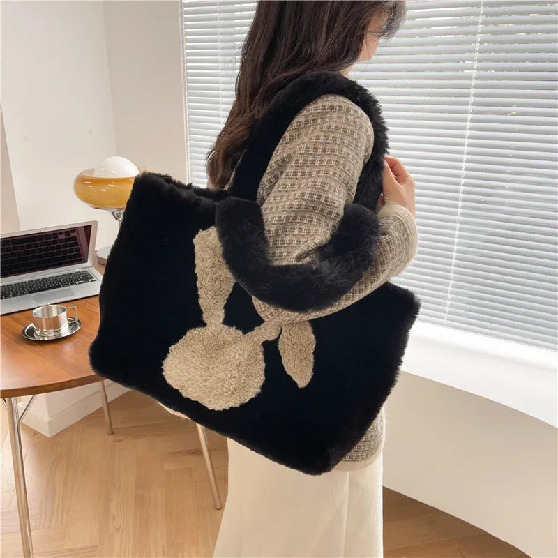 Soft beige plush tote bag with cartoon rabbit ears on the front, shown as a large capacity shoulder bag.