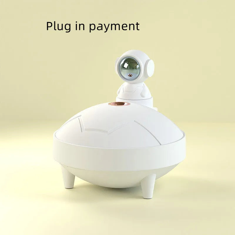 Astronaut sunset lamp humidifier with 360 degree rotating head in green colour, placed on a nightstand