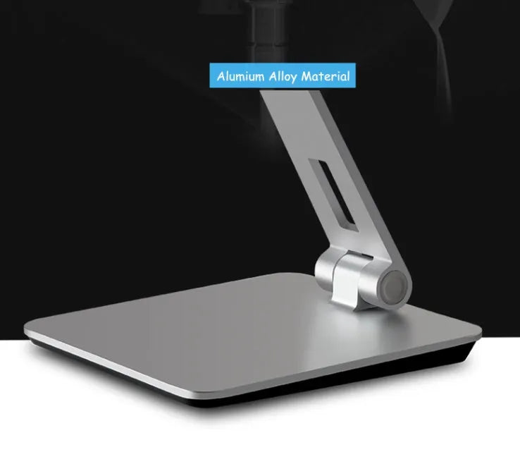 Silver foldable aluminium phone and tablet stand on a desk, holding a tablet at an angle.