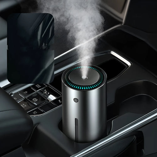 Black aluminium car humidifier and air purifier unit with USB cable on a car dashboard.